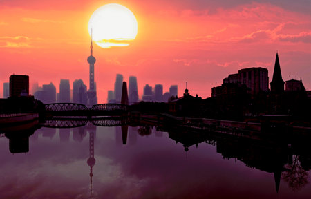 skyline of shanghai at sunset with reflection in the waterの写真素材