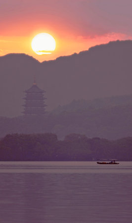 Sunset at the lake in Hangzhou, China. It is a famous tourist attraction.の写真素材