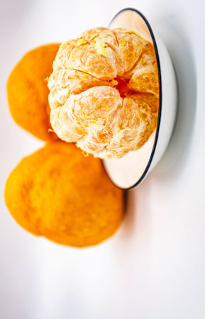 Peeled tangerine on a white background. Selective focus.の写真素材