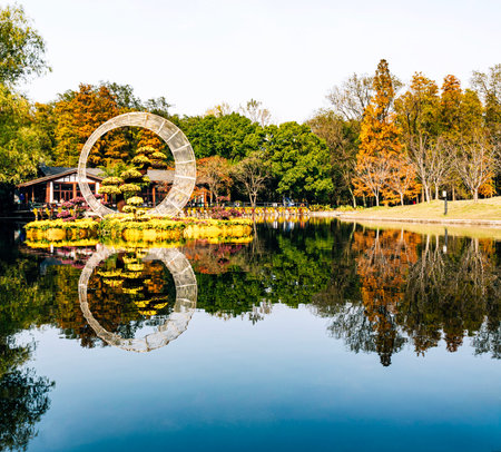 Reflection of pond in the park at autumn season, Thailand.