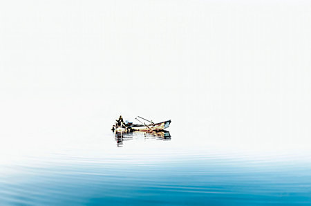Fishing boat on the water surface with blue sky in the background