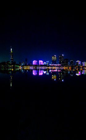 Night view of the city skyline with reflection in the lake, Hangzhou, Chinaの写真素材