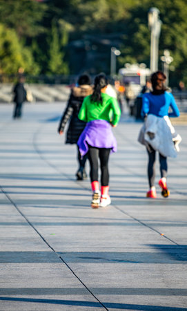 Group of young women running in the park in the morning. Blurred backgroundの写真素材