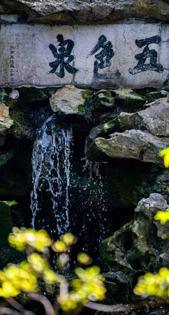 Waterfall in the park, chinese calligraphy on stoneの写真素材