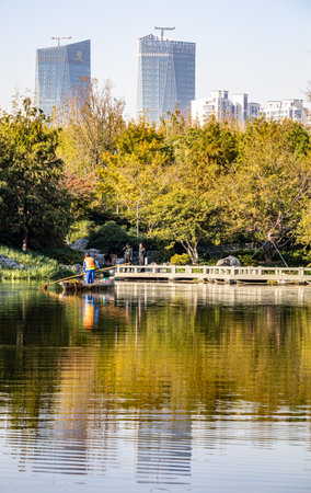 Autumn landscape with lake and skyscrapers in Beijing, Chinaの写真素材