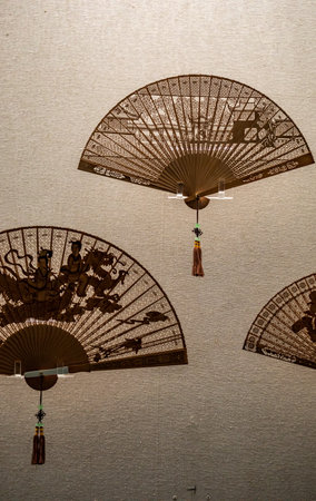 Chinese traditional paper fan on the wall of a temple in Beijing, Chinaのeditorial素材