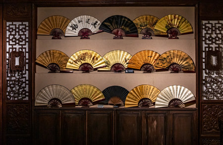 Hand fan on the wallの写真素材