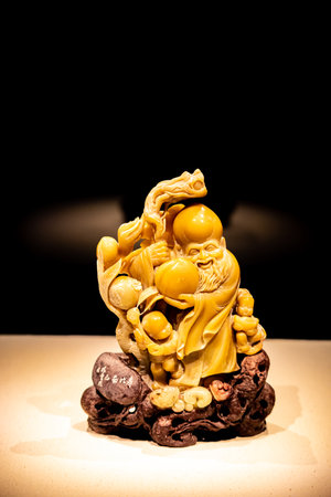 Statue on a black background, closeup of photoの写真素材