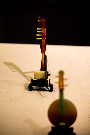 Close-up of a wooden toothbrush on a stand against a black background