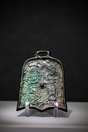 Chinese ancient bronze bell on a black background, closeup of photo