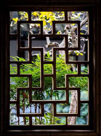 The window is decorated with a wooden lattice in the garden.の写真素材