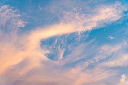 Cloudscape, Colored Clouds at Sunset near the Ocean in a Blue Skyの写真素材