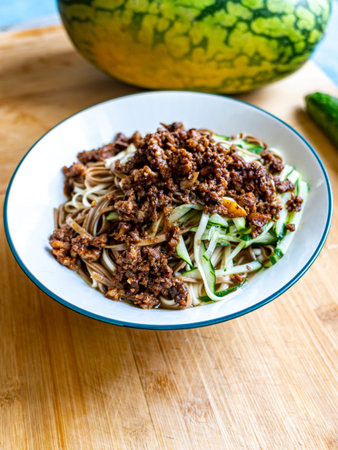 Bowl of spicy instant noodle with minced meat and cucumberの写真素材