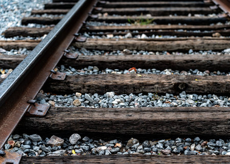 Railway tracks with pebbles, close-up view.