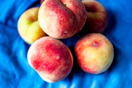 Fresh peaches on a blue background. Selective focus. nature.の写真素材
