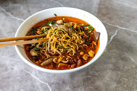 Chinese noodle soup with pork and bean sprouts in a bowl
