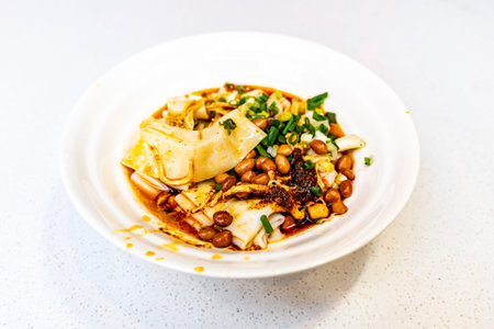 Fried tofu with bean and soy sauce in white plate