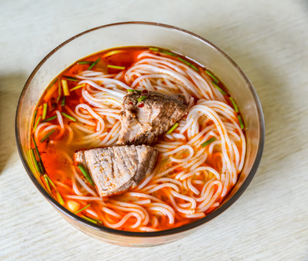 Vietnamese noodle soup with beef and vegetables in a bowlの写真素材