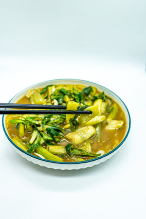 Noodle soup with pork and eggplant in bowl on white backgroundの写真素材