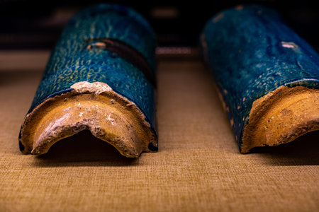 Vintage ceramic tile on a rustic background. Selective focus. Toned.