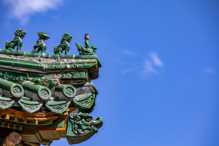 Architectural detail of the roof of a Buddhist temple in Chinaの写真素材