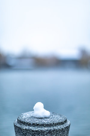 Snow on the railing of a bridge in the city, blurred backgroundの写真素材