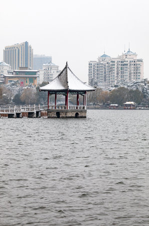 Pavilion on the lake in the city park in winter.の写真素材
