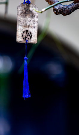 Close up of a traditional lucky knot hanging on a treeの写真素材