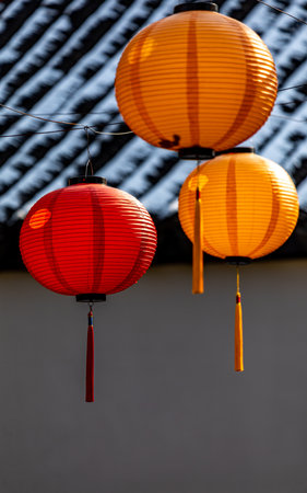 Colorful Chinese lanterns hanging on the wall with a dark backgroundの写真素材