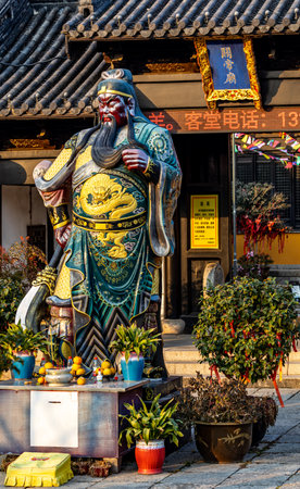 Statue of the Chinese god of wealth at an ancient Chinese templeの写真素材