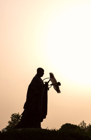 Silhouette of a statue of the Virgin Mary and the baby Jesusの写真素材