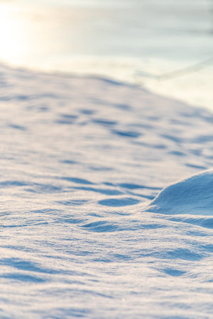 Winter landscape. Snowdrift on a background of the sun.