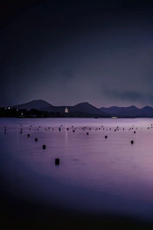 Night view of the sea and mountains in the background. Long exposure.の写真素材