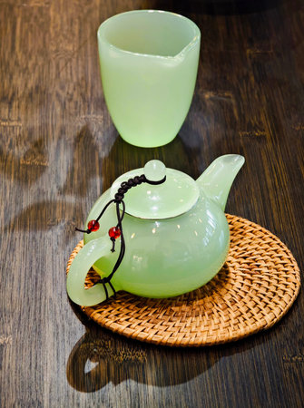 teapot and tea cup on wooden table in chinese restaurantの写真素材