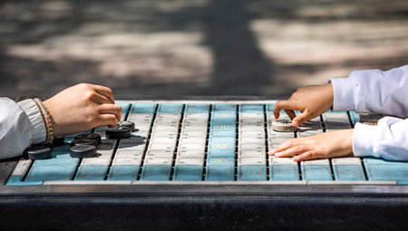 Close up of hands of a man and a woman playing a game on a board.