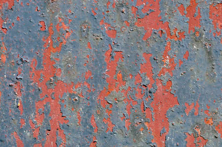 Old blue red paint is peeling off the branの写真素材