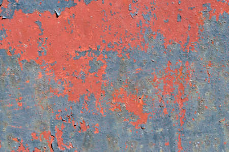 Old blue red paint is peeling off the branの写真素材