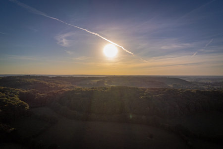 Sun setting over forrest hills in the Eifel region in West Germany