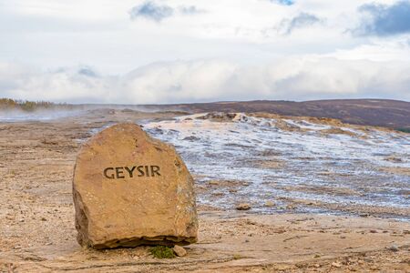 Geysir Golden Circle in Iceland name cut in rock in front of the geothermal areaの写真素材