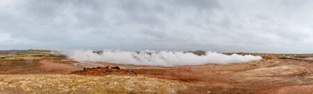 Geo Thermal hot spring activity in Iceland Gunnuhver Hot Springs steam cloud during heavy windの写真素材