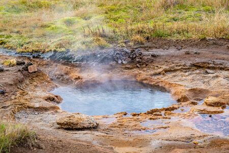 Geysir Golden Circle in Iceland boiling hot geothermal spring spitting mud and waterの写真素材