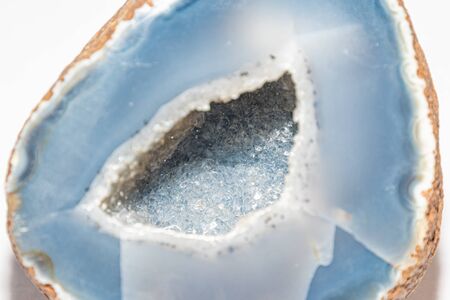 Blue colored geode outside looking like usual rock inside full of tiny shiny crystalsの写真素材
