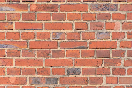 Old red brick dutch clinker facade of industrial building close up texture