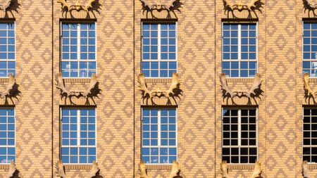 Beige dutch brick facade texture with deer antlers and diamond patternの写真素材