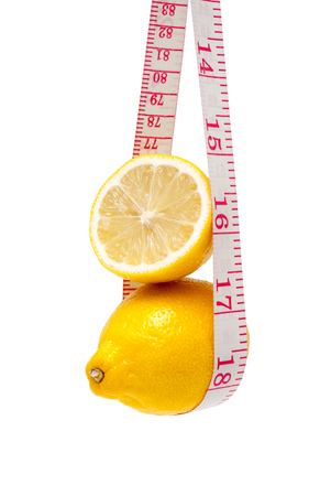 Lemon and tape measure isolated on white backgroundの写真素材