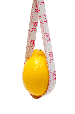 Lemon and tape measure isolated on white backgroundの写真素材