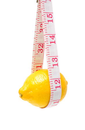Lemon and tape measure isolated on white backgroundの写真素材