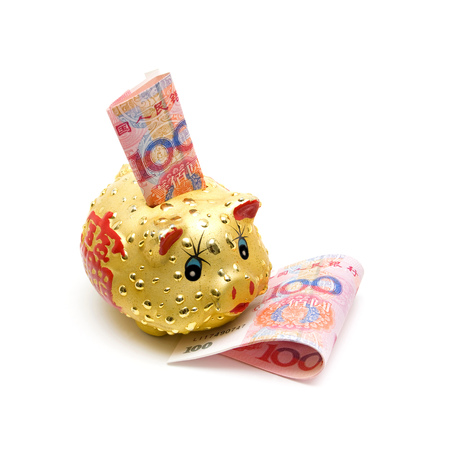 Piggy bank and Chinese yuan note isolated on white backgroundの写真素材
