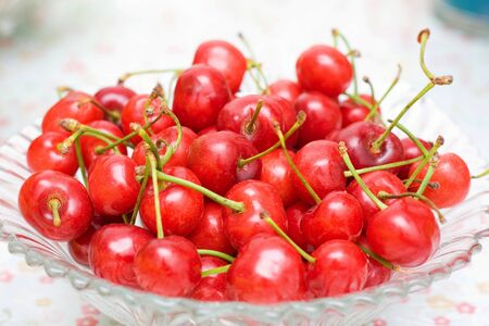 Fresh cherries in bowl on tableの写真素材