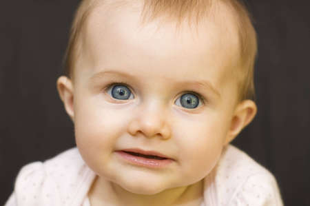 Portrait of a baby girl on a black backgroundの写真素材